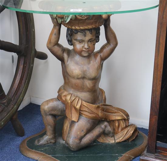 A carved Venetian style amorini table base, with plate glass top, H.70cm